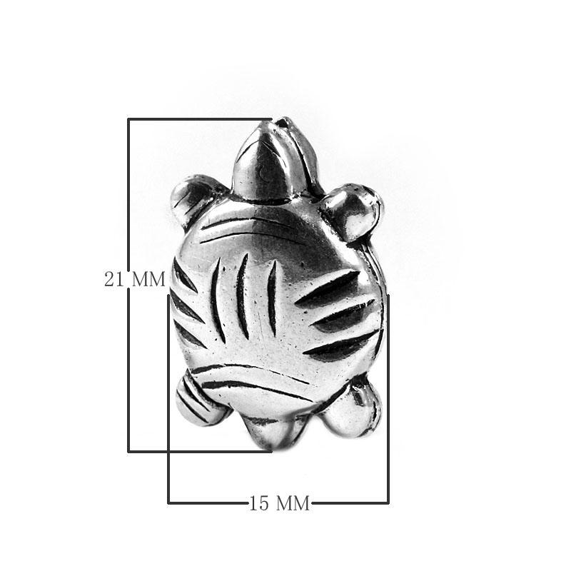 Silver overlay over copper charm handcrafted in India with turtle design and oxidized silver finish
