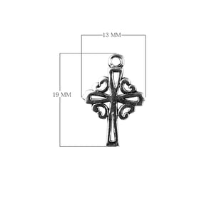 Handcrafted silver overlay ornate cross charm made with silver overlay over copper featuring decorative scroll design in India.