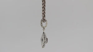 Diamond-shaped sterling silver pendant featuring citrine quartz square center with filigree engravings and polished finish in traditional Balinese design.