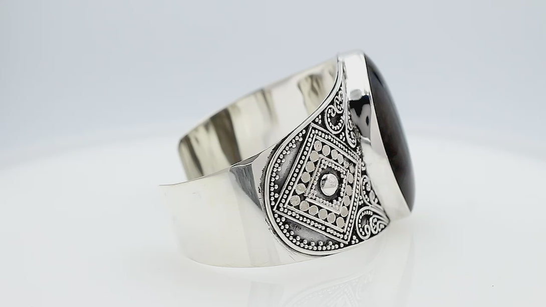 925 sterling silver wide Balinese bangle with Labradorite centerpiece and ornate scroll detailing.