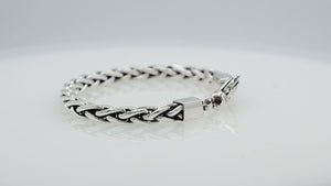 Wholesale sterling silver bracelet featuring a braided chain and decorative lobster clasp handcrafted in Bali.