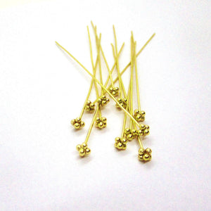 Gold-overlay copper pin with textured triple-bead decorative head.