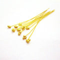 Long 18K gold overlay copper head pin with granulated tri-bead top.