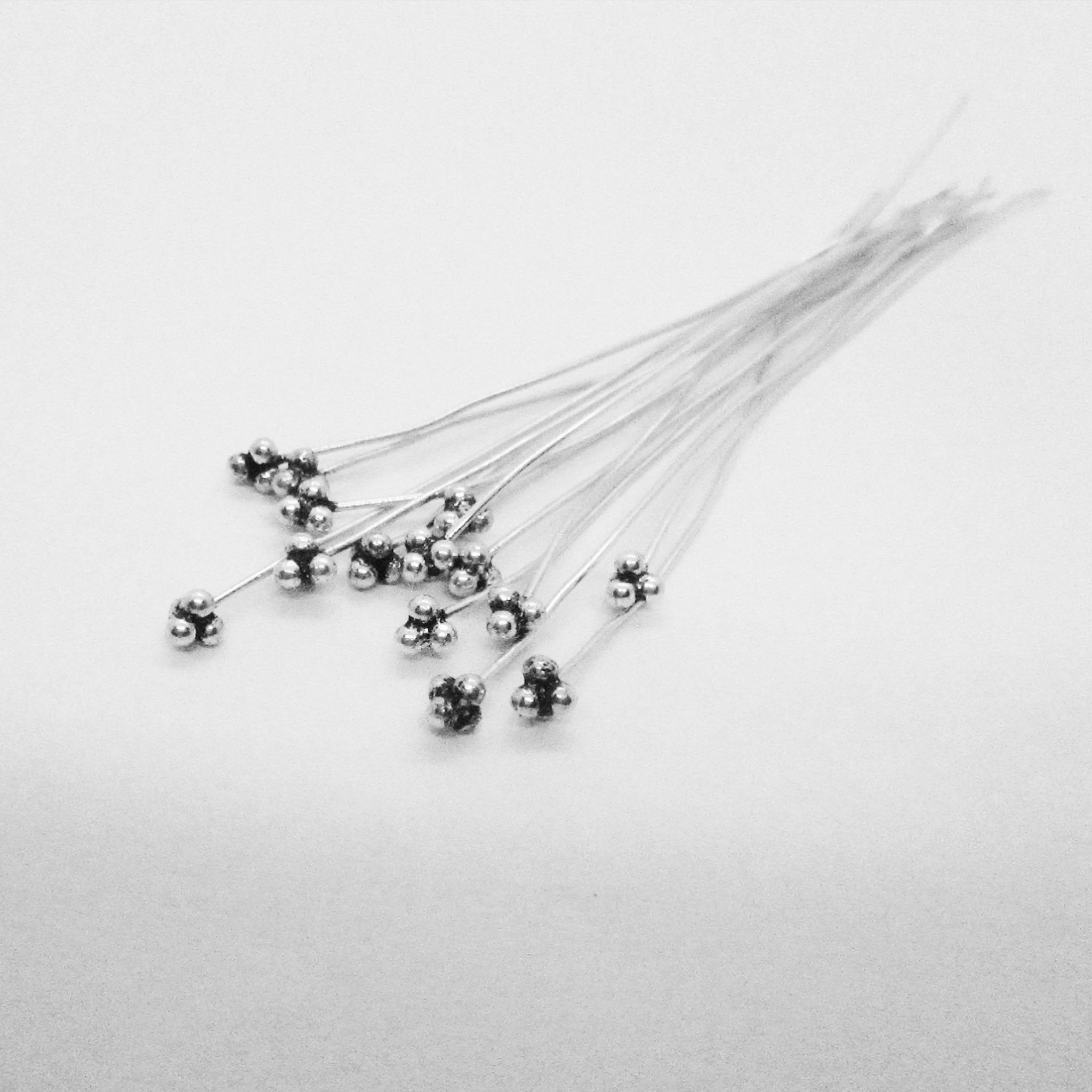 Handcrafted silver overlay over copper triple-ball head pin made in India for wholesale jewelry production.