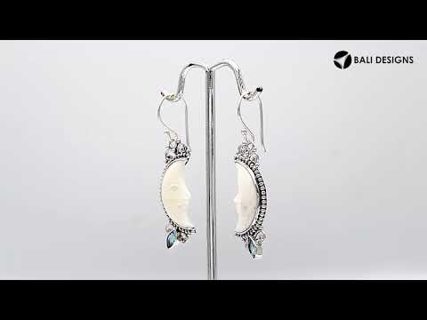 Sterling silver lunar bone face earrings with blue topaz quartz accent and earwire lock