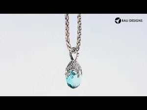 Sterling silver heart pendant with blue topaz quartz and ornate Balinese handcrafted pattern