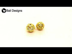 Handcrafted embossed round bead with circular motifs and 18K gold overlay over copper, made in India for wholesale jewelry production.