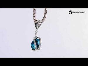 A handcrafted sterling silver pendant featuring a sparkling Blue Topaz Quartz set in a dual rope silver frame with detailed Balinese craftsmanship.