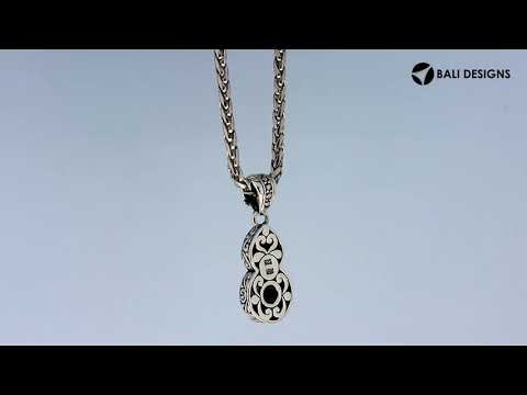 Teardrop silver pendant with pearl, gold details, and diamond accents