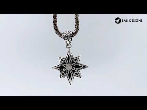 A handcrafted sterling silver compass star pendant featuring detailed Balinese tribal engraving and polished silver craftsmanship.