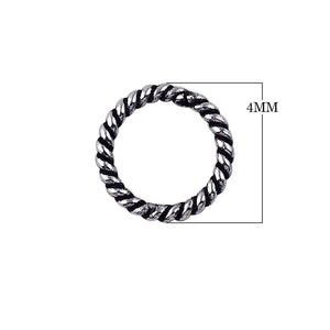 Handcrafted twisted closed jump ring in sterling silver with oxidized finish, artisan jewelry component from India.