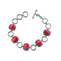 Sterling Silver Bracelet With Cushion Red Coral Stones In Rope Bezels And Large Silver Rings