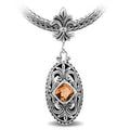 Sterling Silver Ornate Oval Pendant Featuring Citrine Quartz With Fleur-De-Lis Decorative Bail.