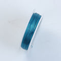 Blue elastic jewelry wire evenly wound around a clear white spool, showcasing a smooth round profile suitable for bracelet making, necklace stringing, beadwork, jewelry designing, and creative craft applications.