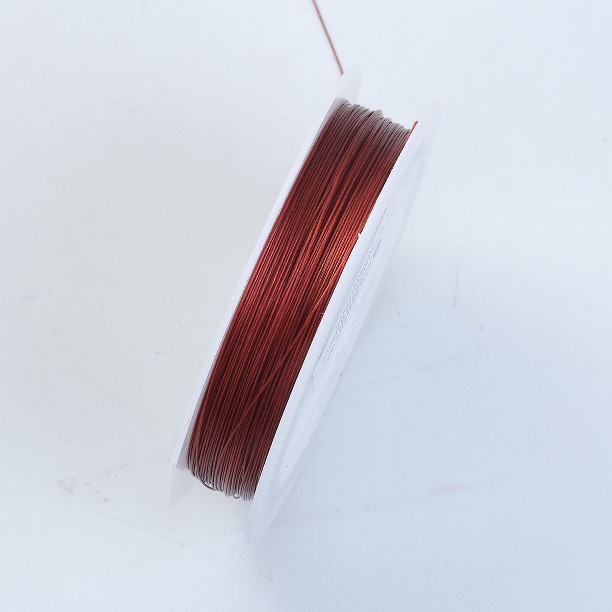 Handcrafted red silver overlay over copper wire spool for jewelry making from India